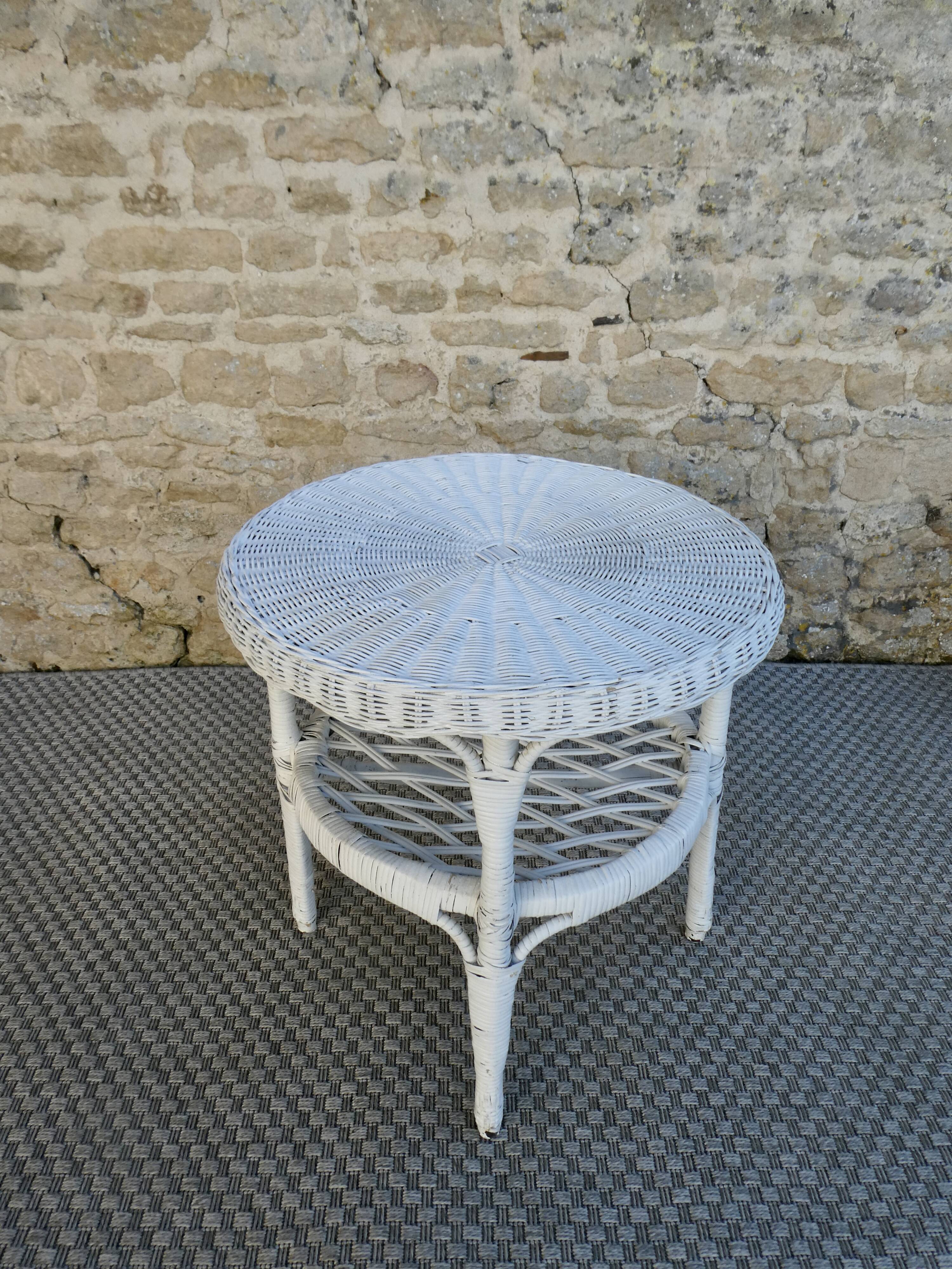 Round white rattan side table with storage underneath, circa 1970.