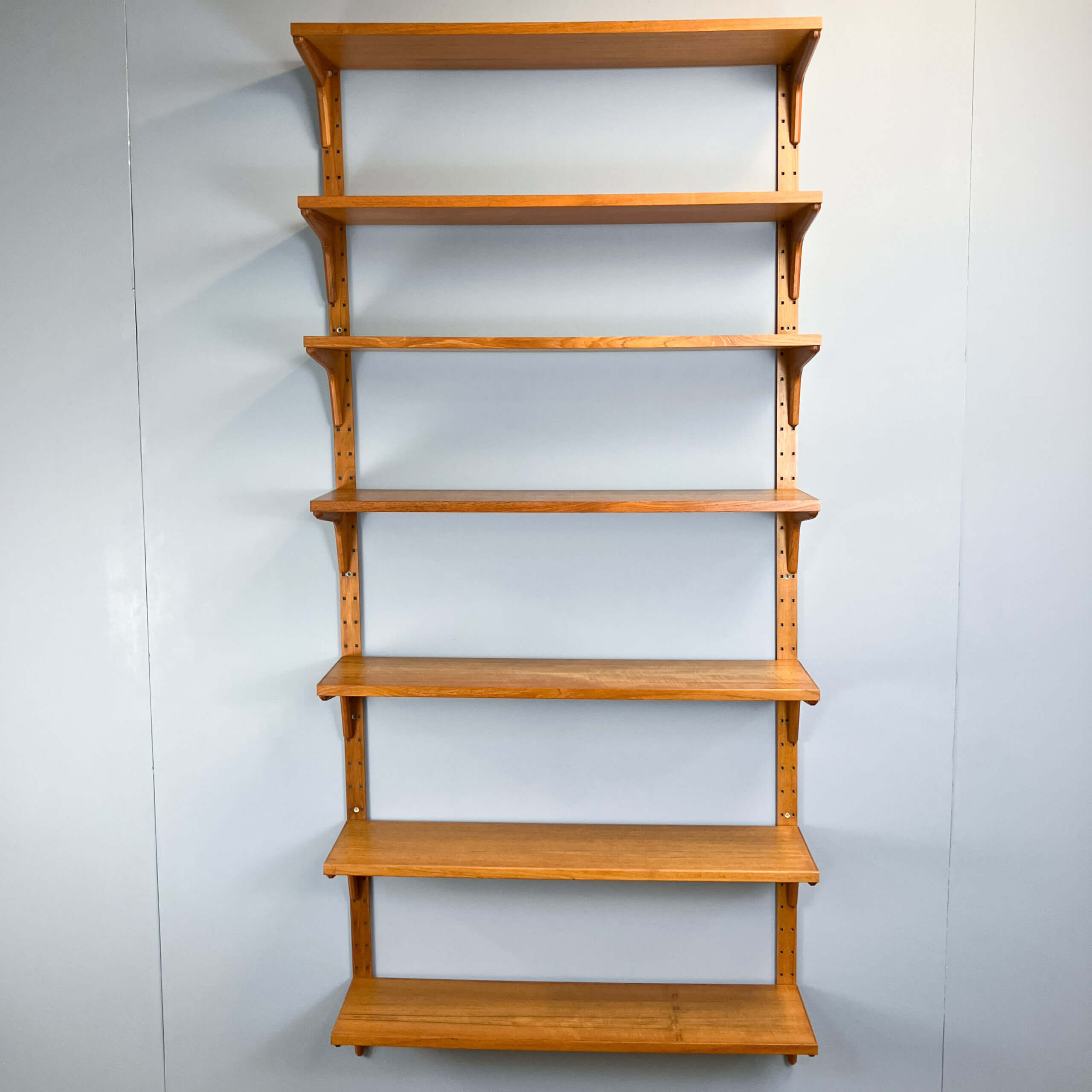 Danish wall shelf by Hansen and Guldborg, teak, aluminum rails, 1960s.