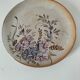 Stoneware plate with hand-painted floral decoration