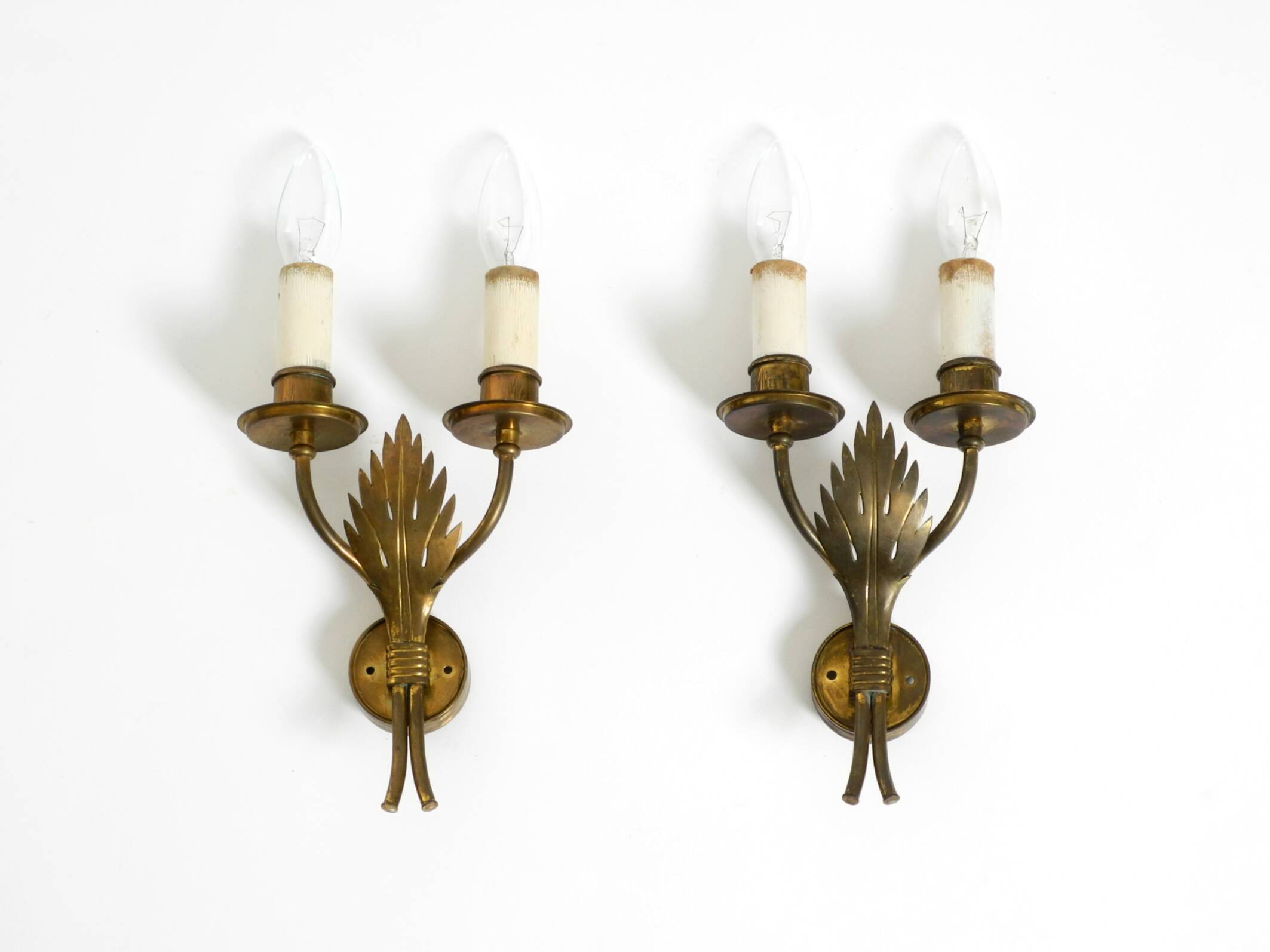 A pair of mid-century modern brass wall lamps by Vereinigte Werkstätten
