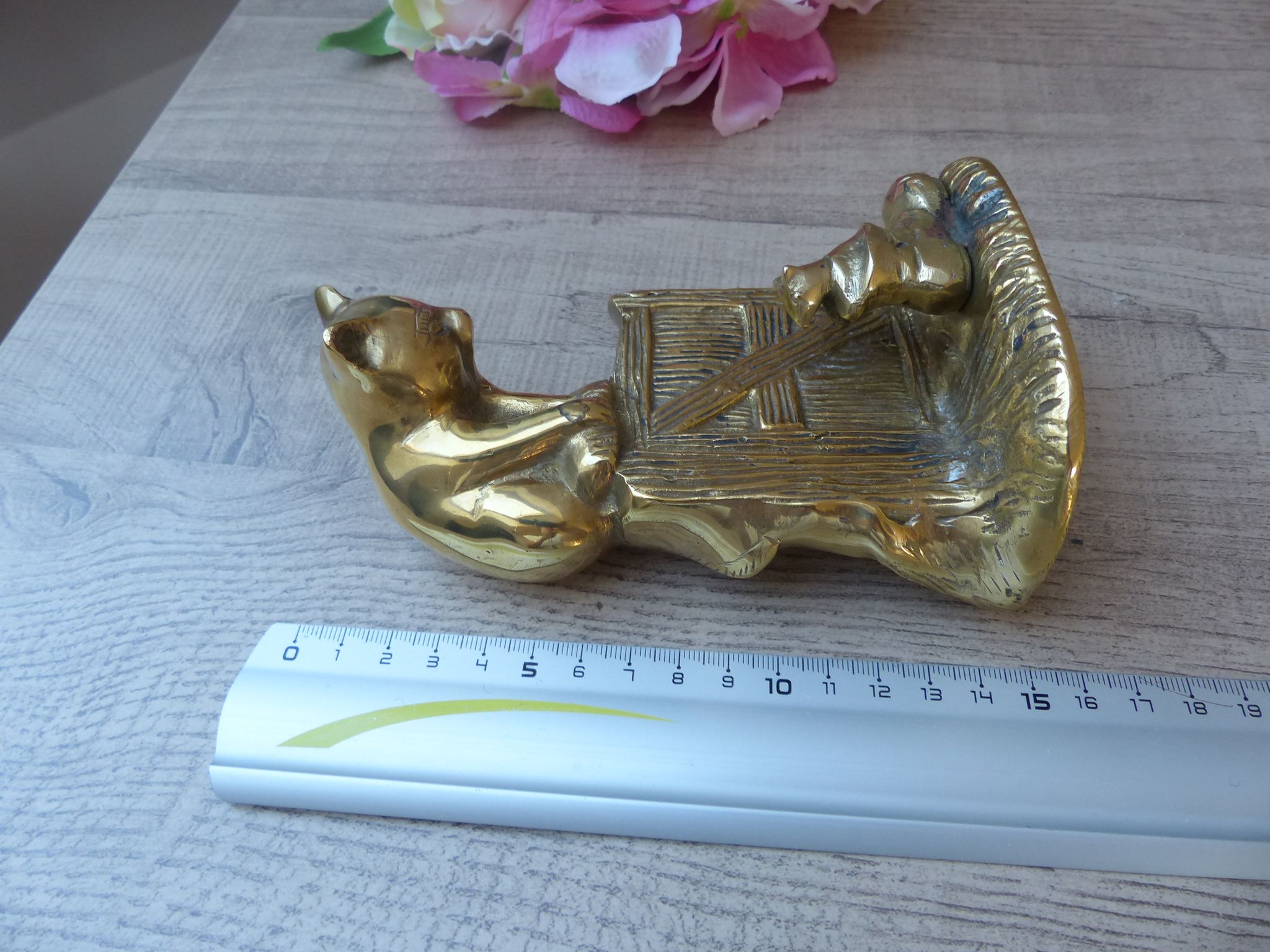 Golden brass cat figurine on fence looking at a mouse in a Vintage India shoe