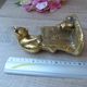 Golden brass cat figurine on fence looking at a mouse in a Vintage India shoe