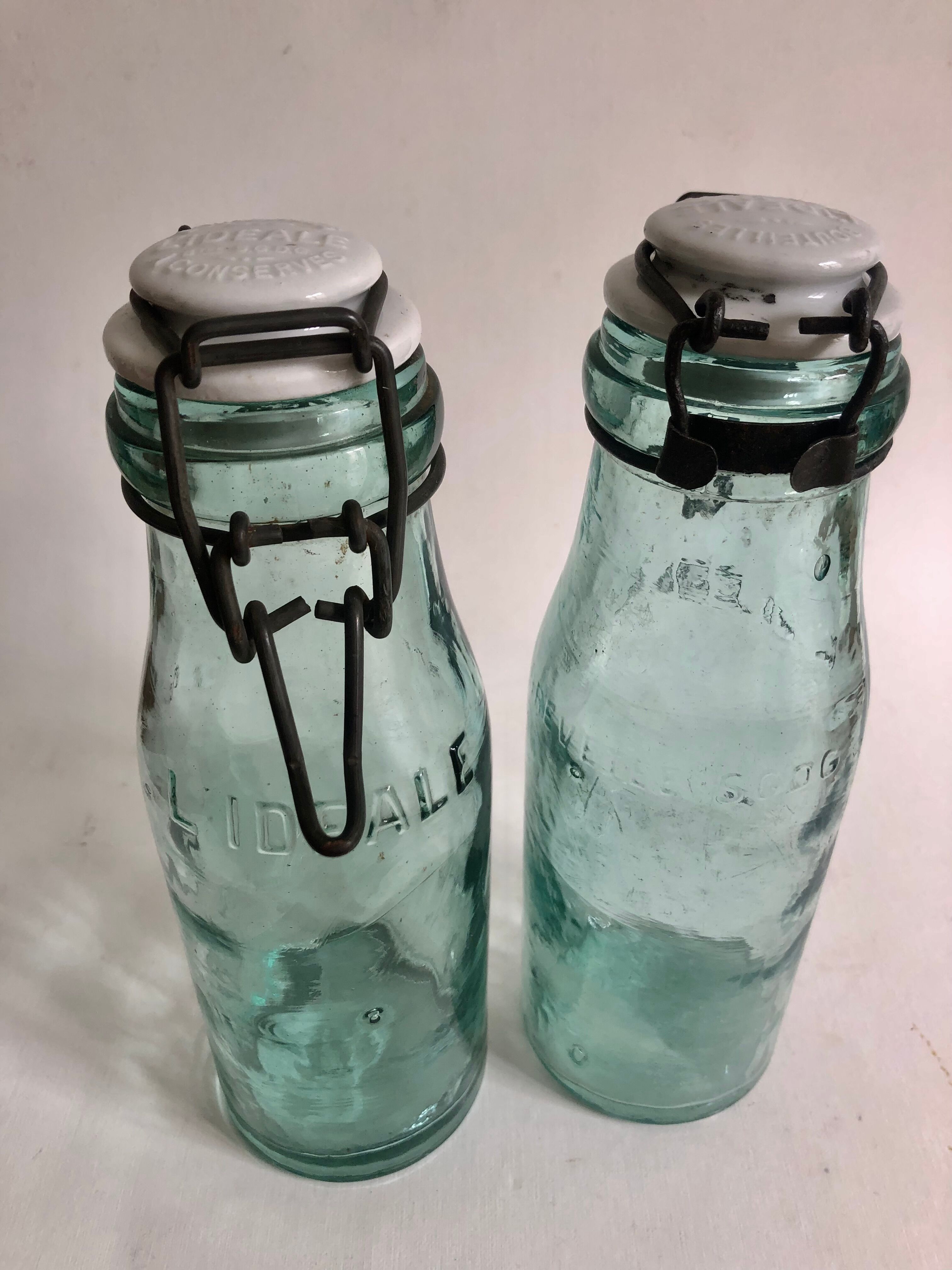 Two bottles with canned goods l'ideale