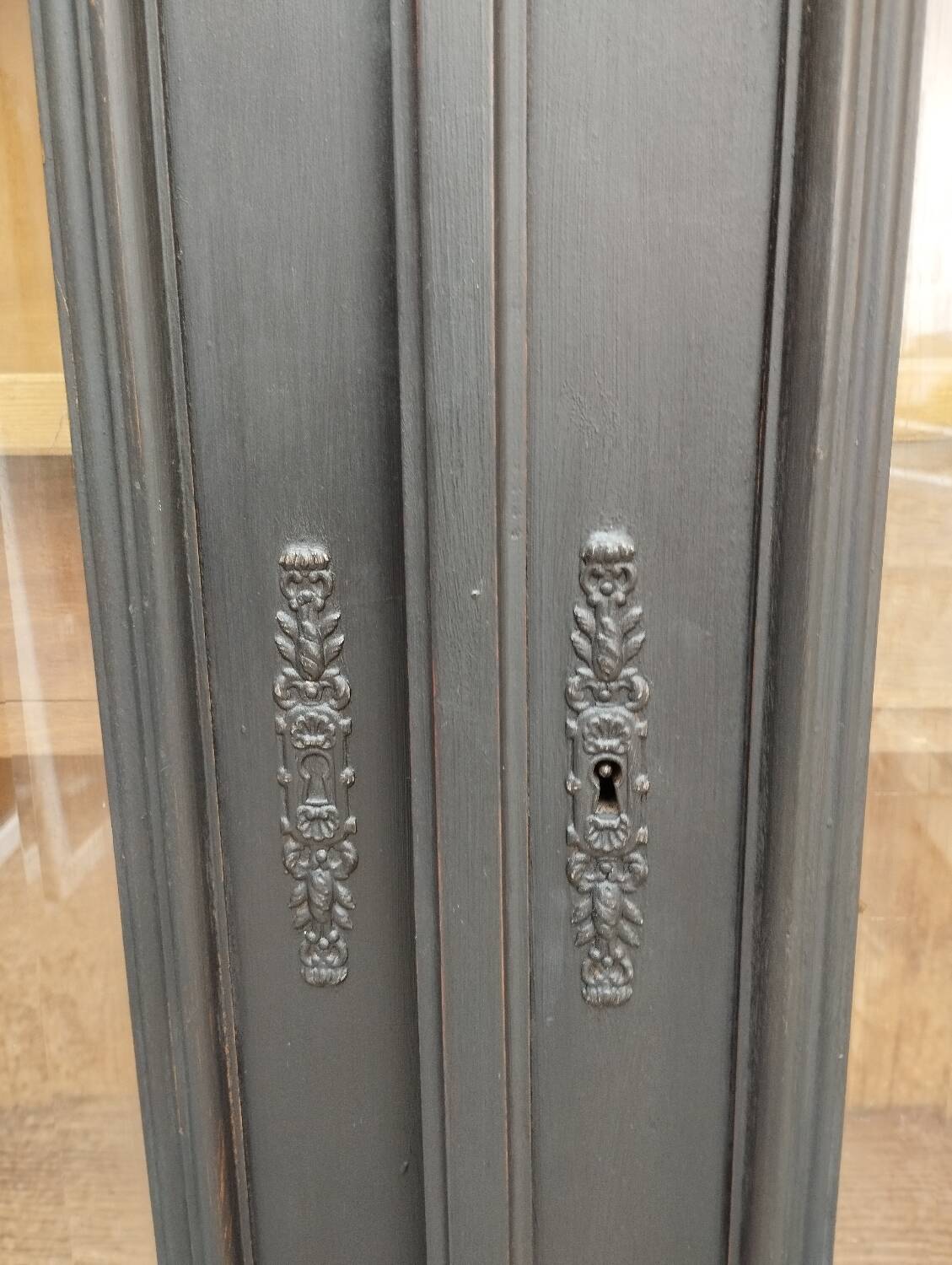 Bookcase black patina shell pediment 2 drawer doors
