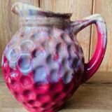 Old pitcher in burgundy ceramic