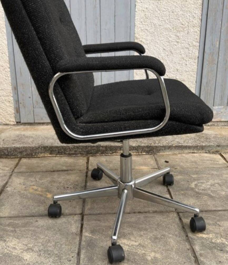 Black mottled fabric and chrome swivel armchair, 1