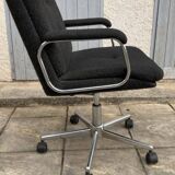 Black mottled fabric and chrome swivel armchair, 1