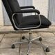 Black mottled fabric and chrome swivel armchair, 1