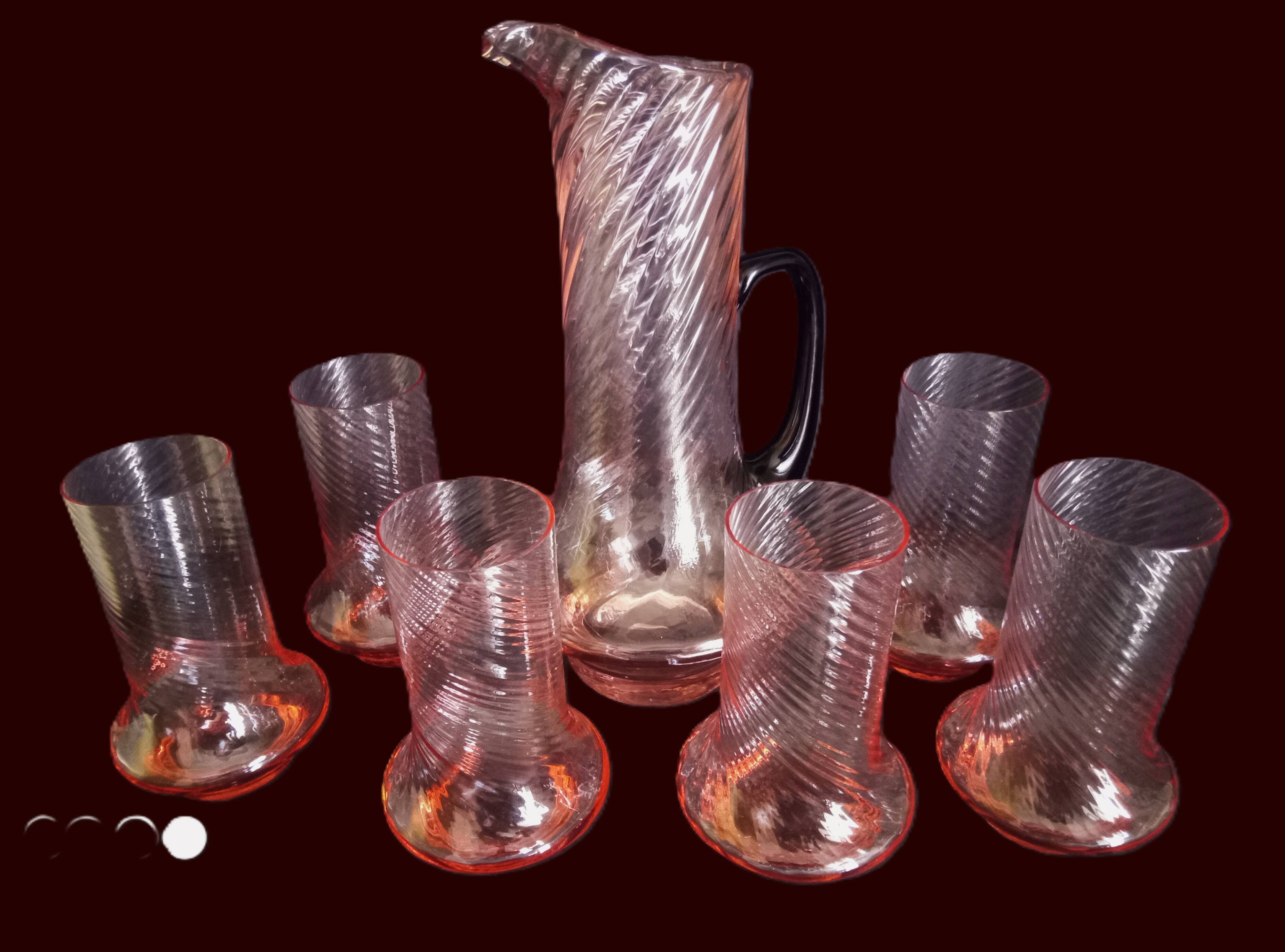 Art Deco orangeade service in pink-orange glass, twisted model.