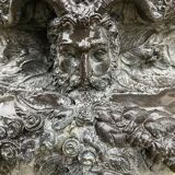 Cast iron vase decorated with mermaids.