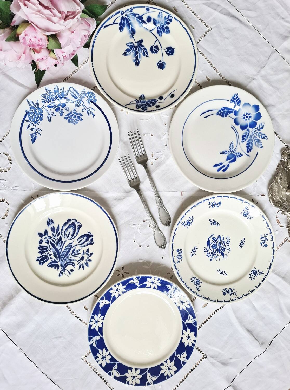 Mismatched antique flat plates accompanied by dishes.