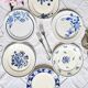 Mismatched antique flat plates accompanied by dishes.