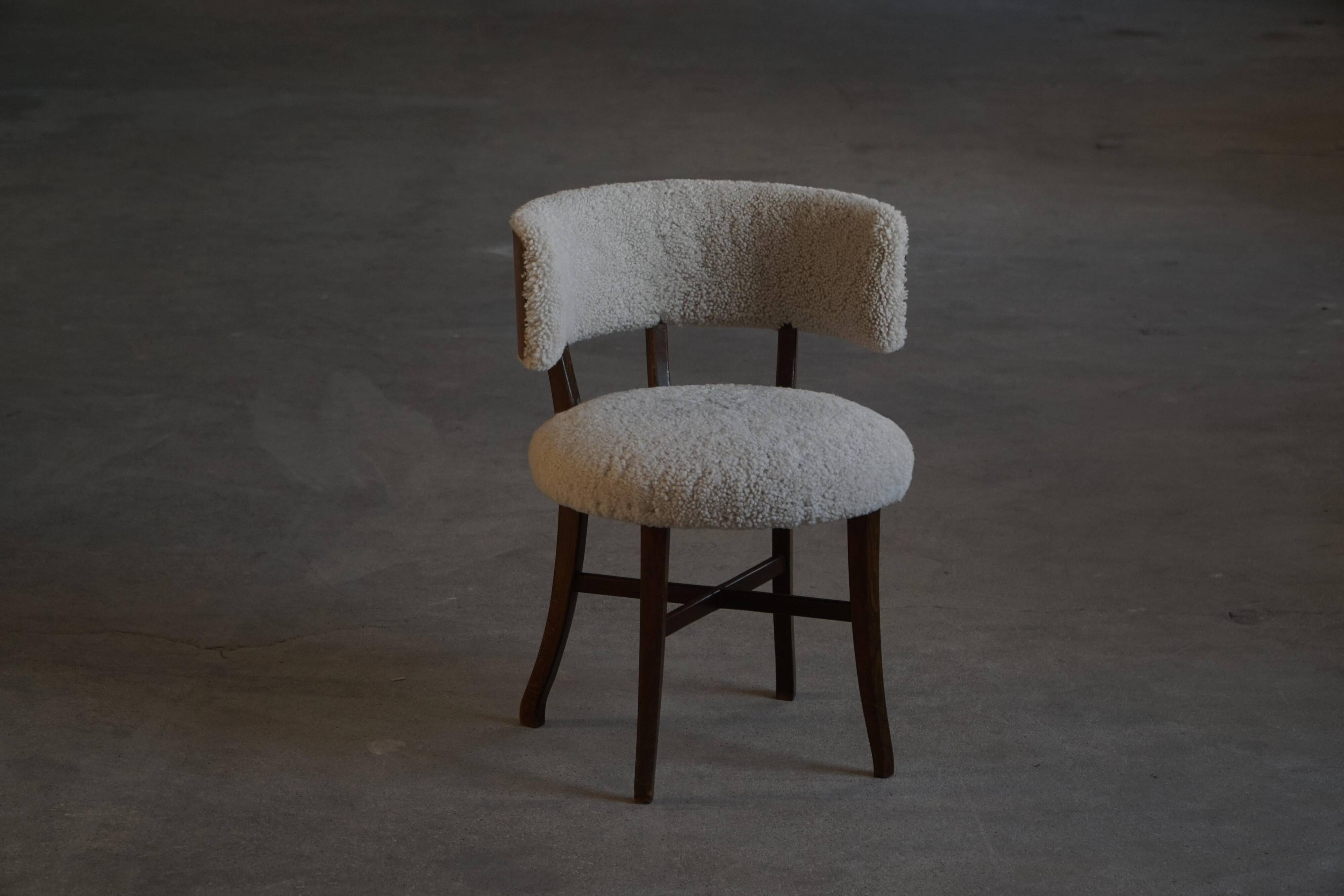 A modern Danish elegant low-back chair, reupholstered in lambswool, 1940s.