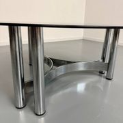 Round coffee table in smoked glass and chrome steel, 1970s design.
