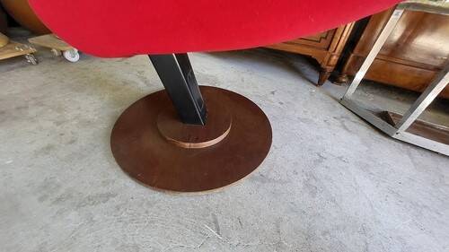 Old cinema chair with a red reclining seat.
