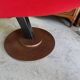 Old cinema chair with a red reclining seat.