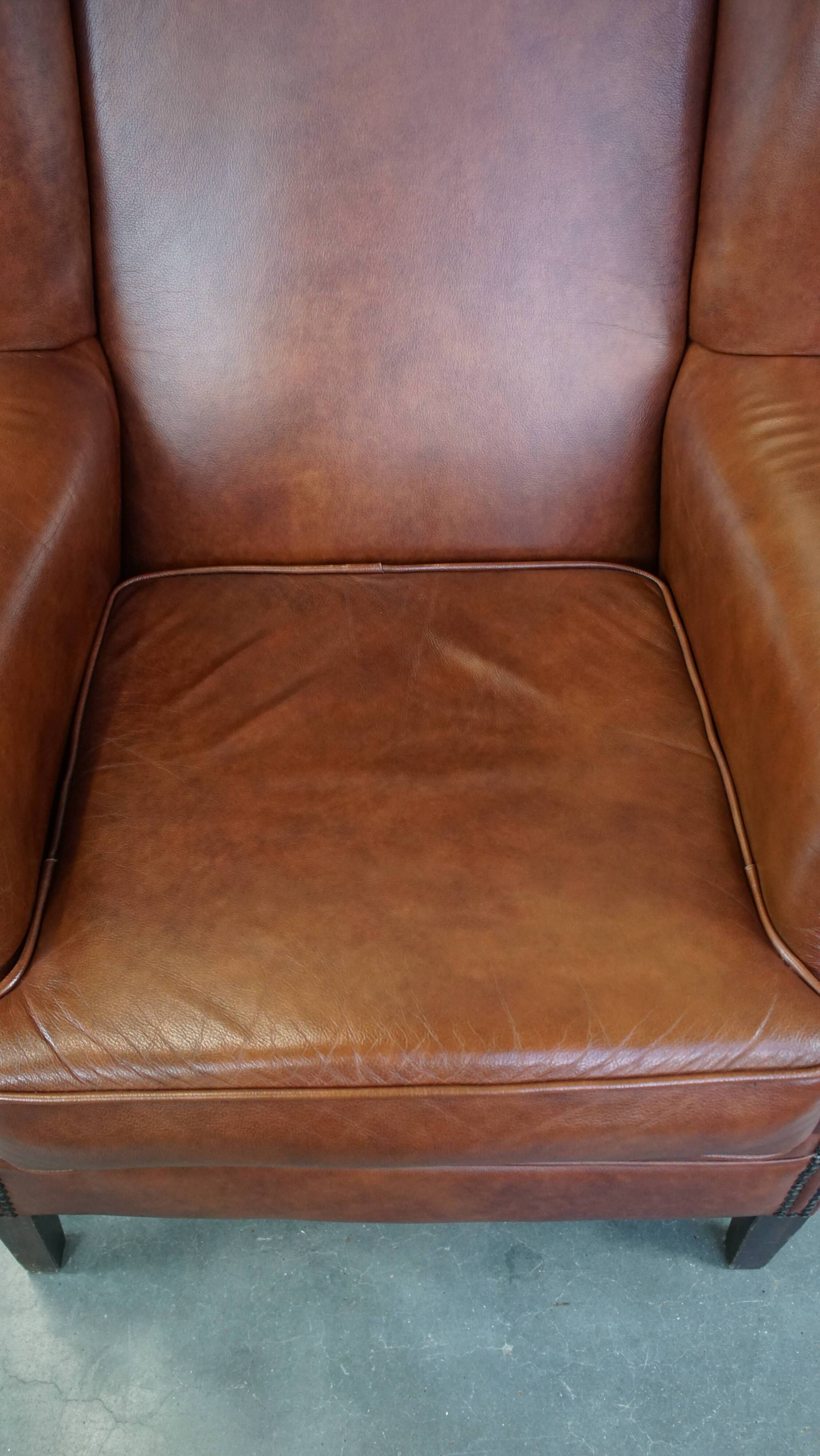 Cognac-colored cowhide wingback chair