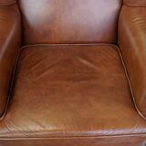 Cognac-colored cowhide wingback chair