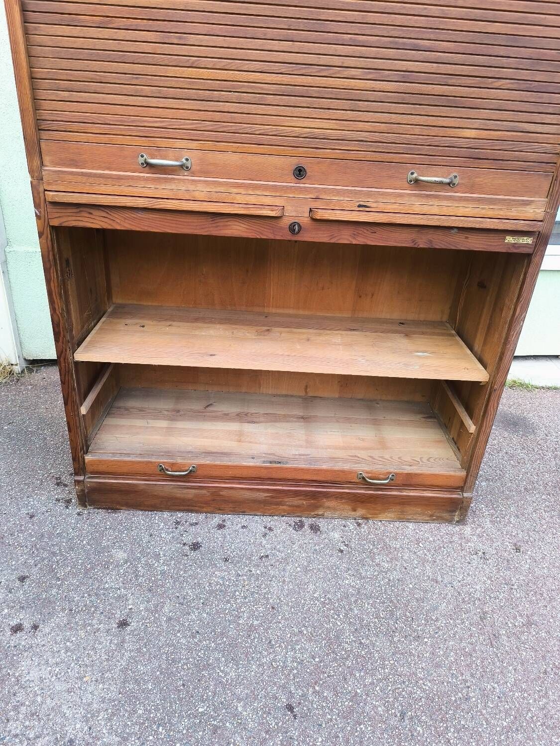 Vintage 1940s secretary desk with wooden curtains, storage, and shutters.