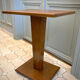 Square pedestal table with central foot 1930
