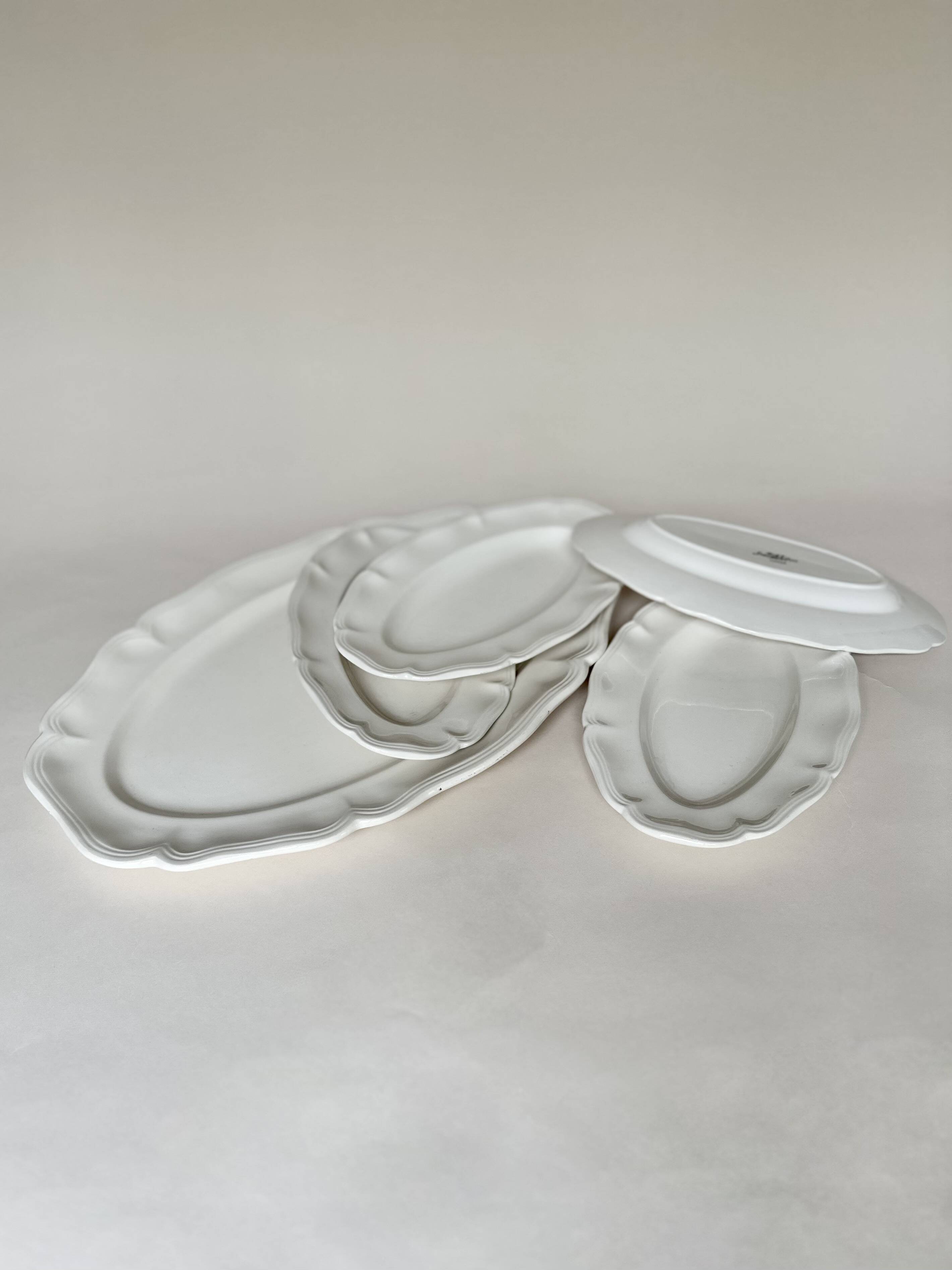 Shaped plates and dishes in Sarreguemines earthenware.