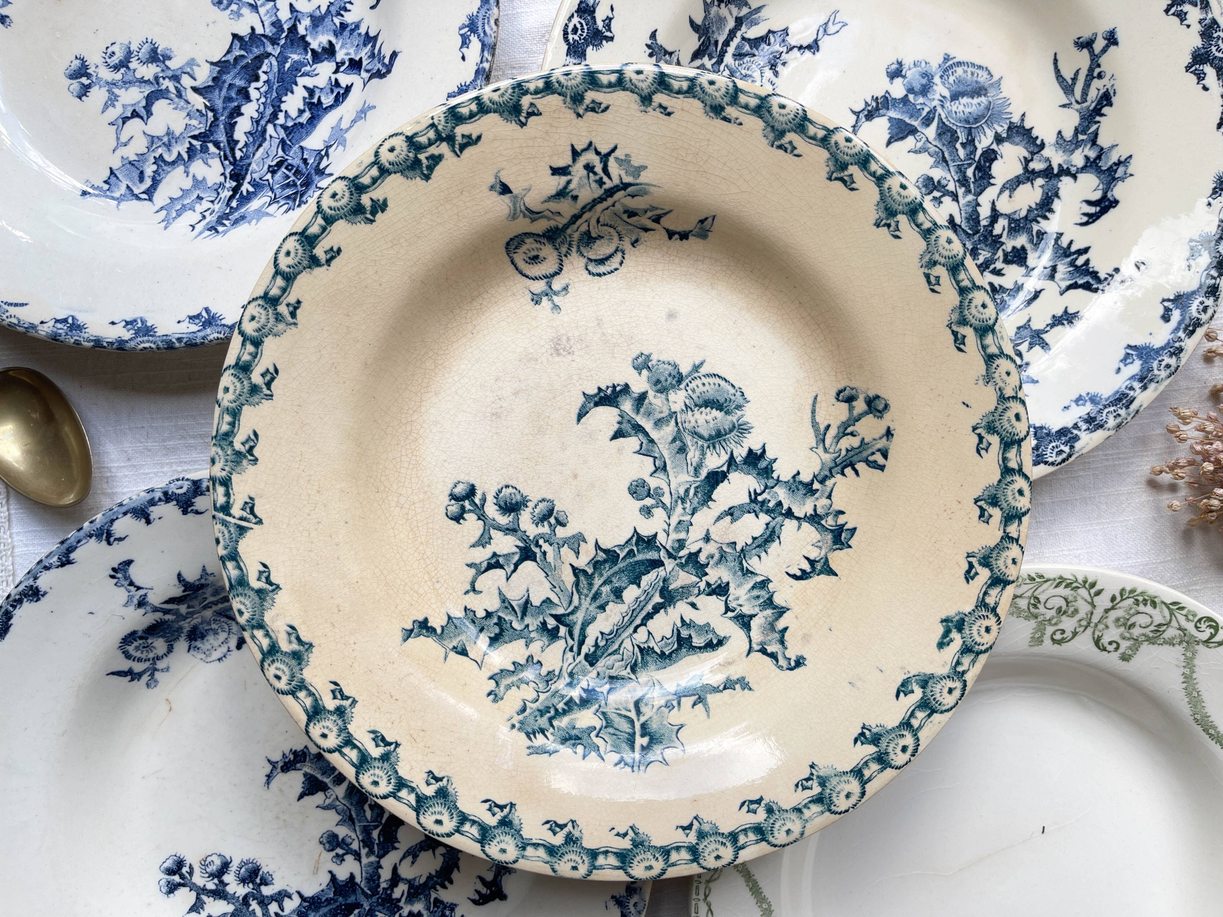 10 mismatched vintage soup plates in blue, green, and red ironstone