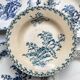 10 mismatched vintage soup plates in blue, green, and red ironstone