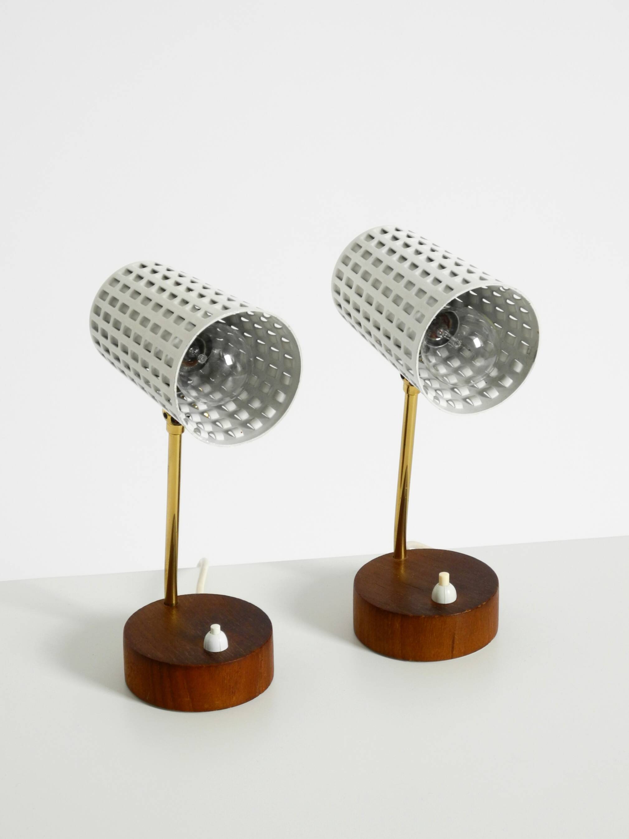 A pair of mid-century modern bedside lamps with perforated metal shades