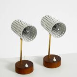 A pair of mid-century modern bedside lamps with perforated metal shades