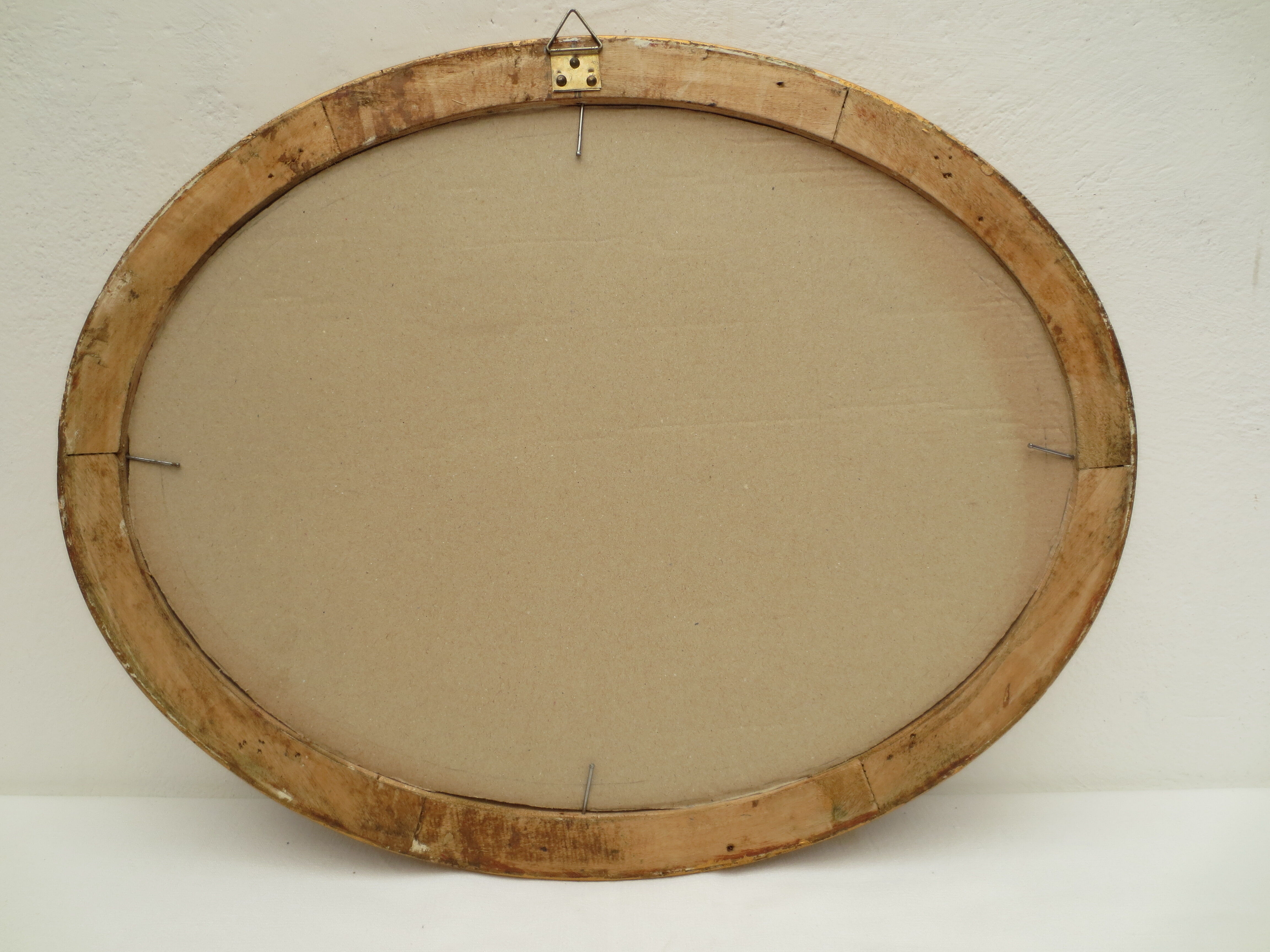 Large old oval gilded wooden frame and stucco decorations