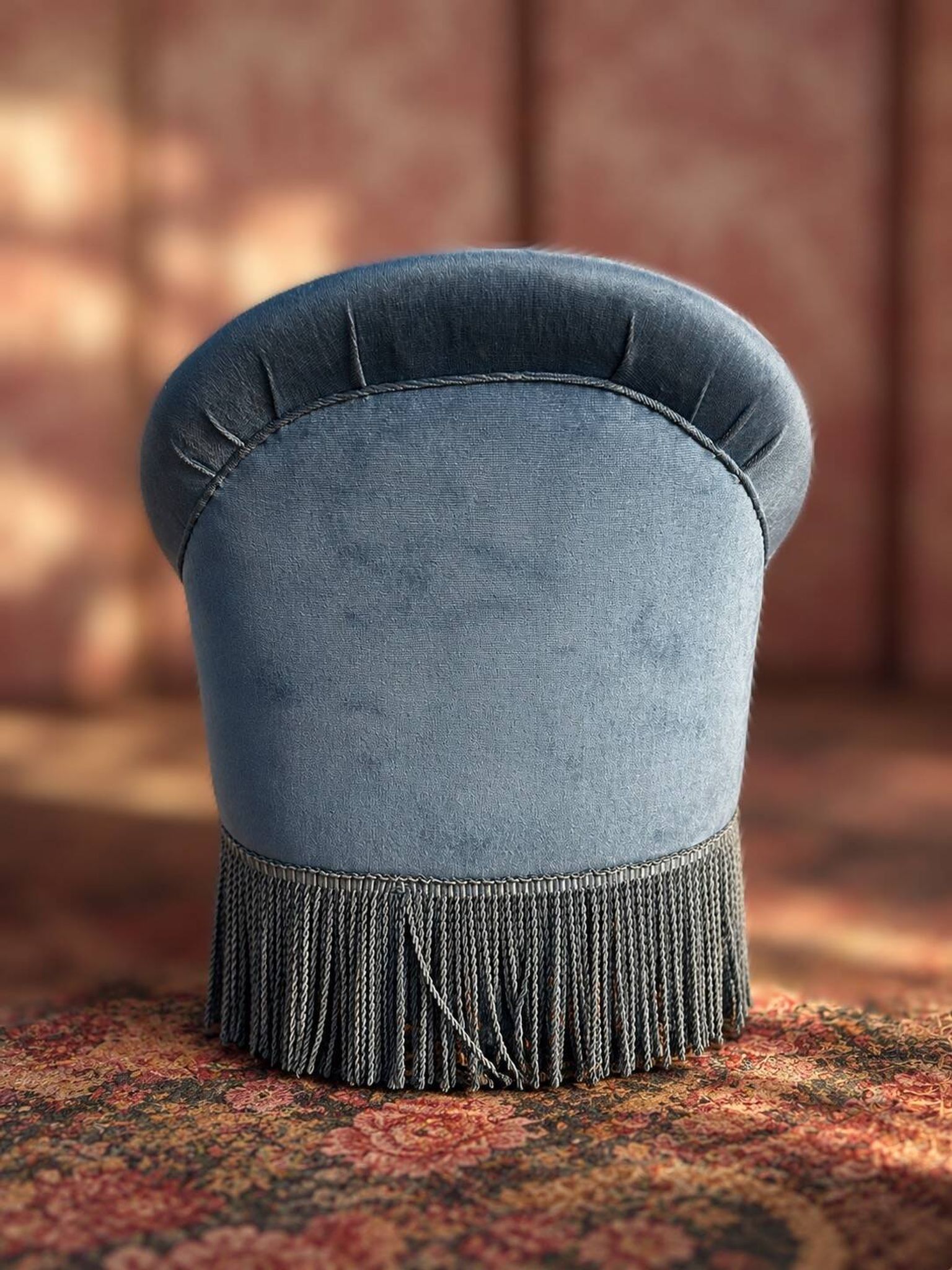 Vintage blue velvet frog chair, a timeless comfortable piece.