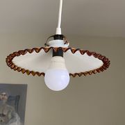 Old pendant light with a white opaline glass shade and a wavy border.