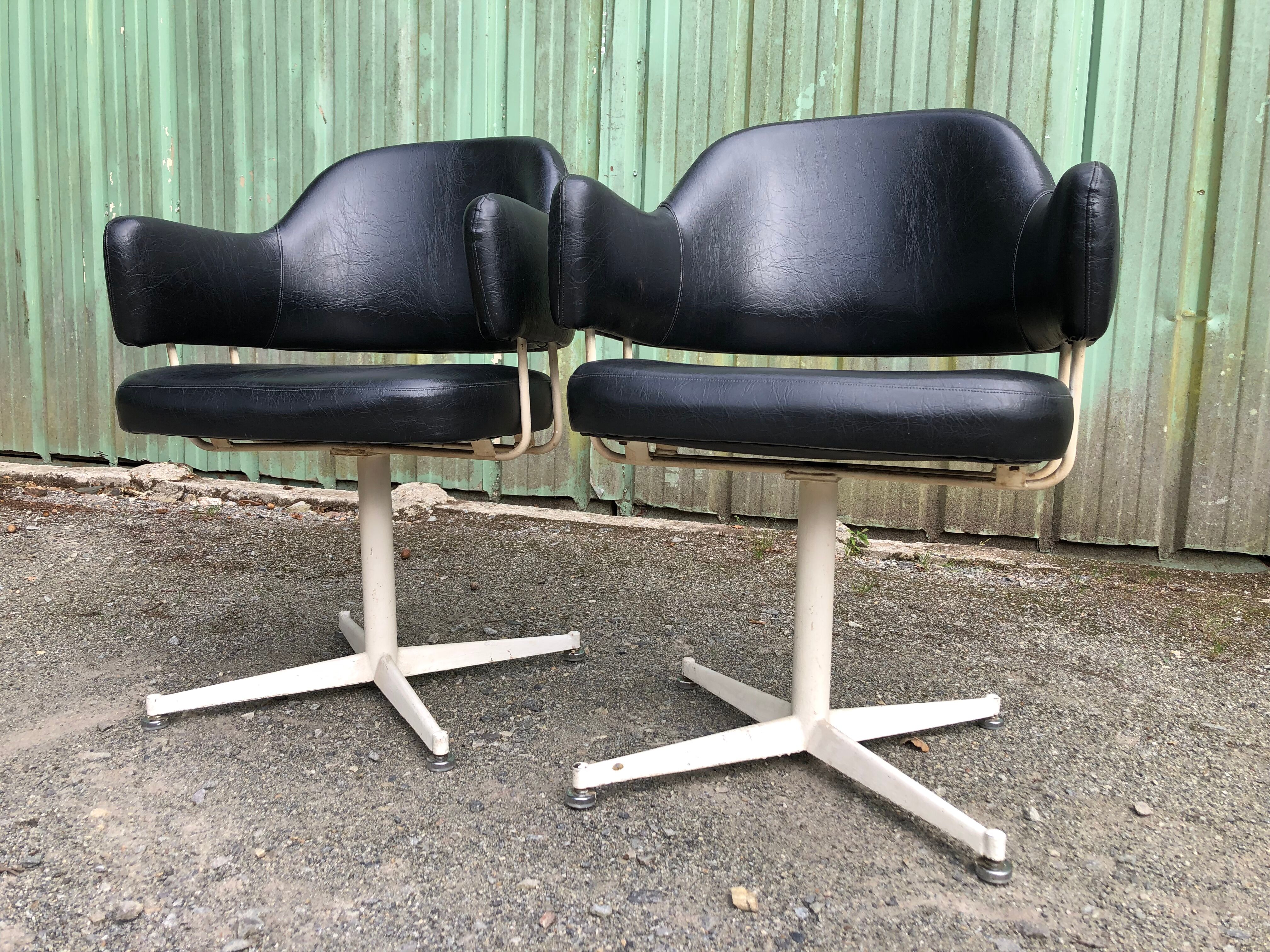 Pair of vintage armchairs in black skai with metal legs.