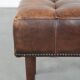 Beautiful sheepskin ottoman on high legs and beautiful warm colours