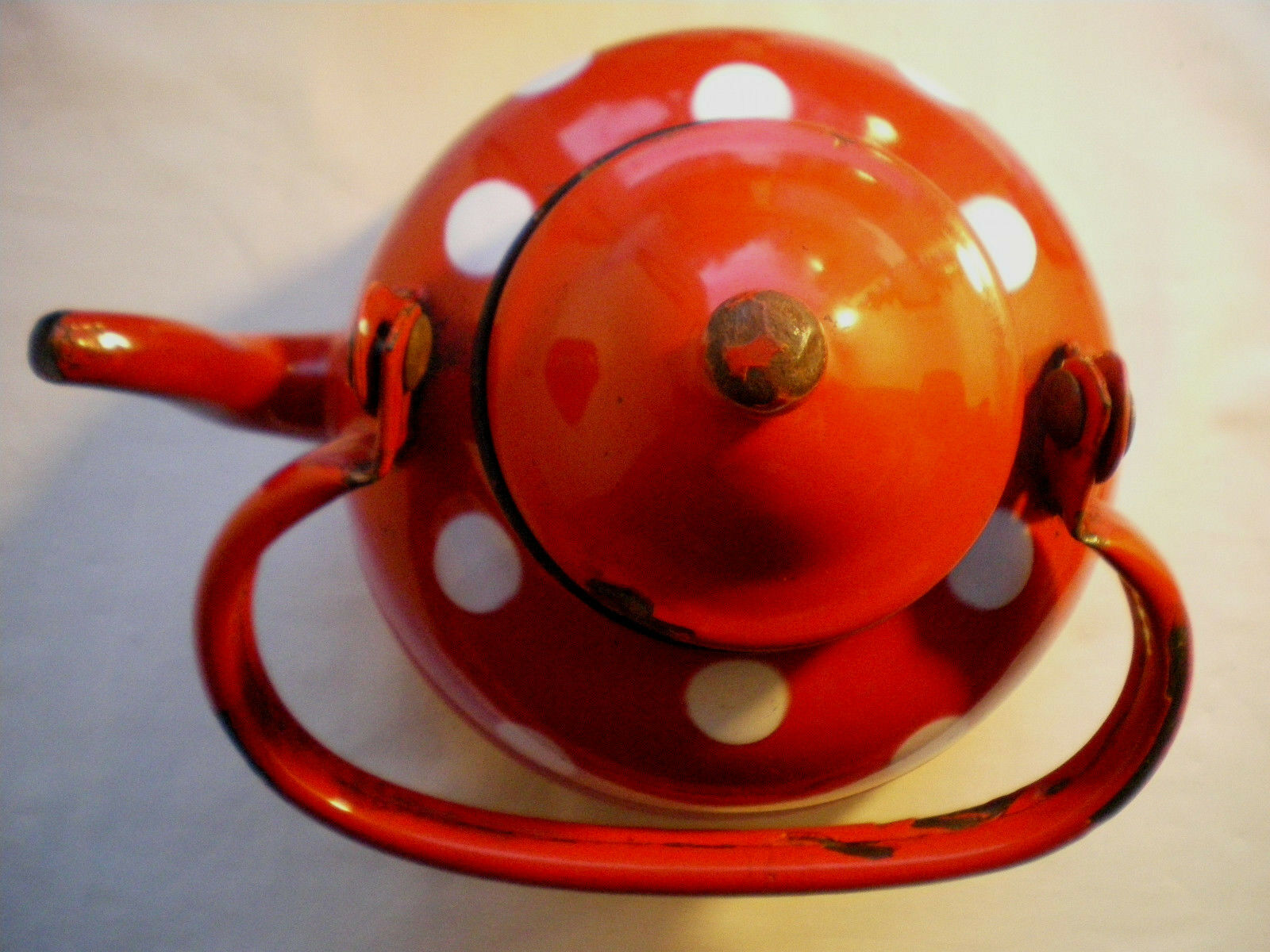 Vintage kettle in red enamelled sheet with white polka dots