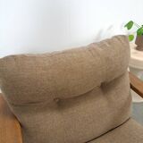 Brown-grey armchair with an oak frame.