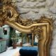 Antique mirror 169/105cm with pediments and pearl detailing in gold leaf.