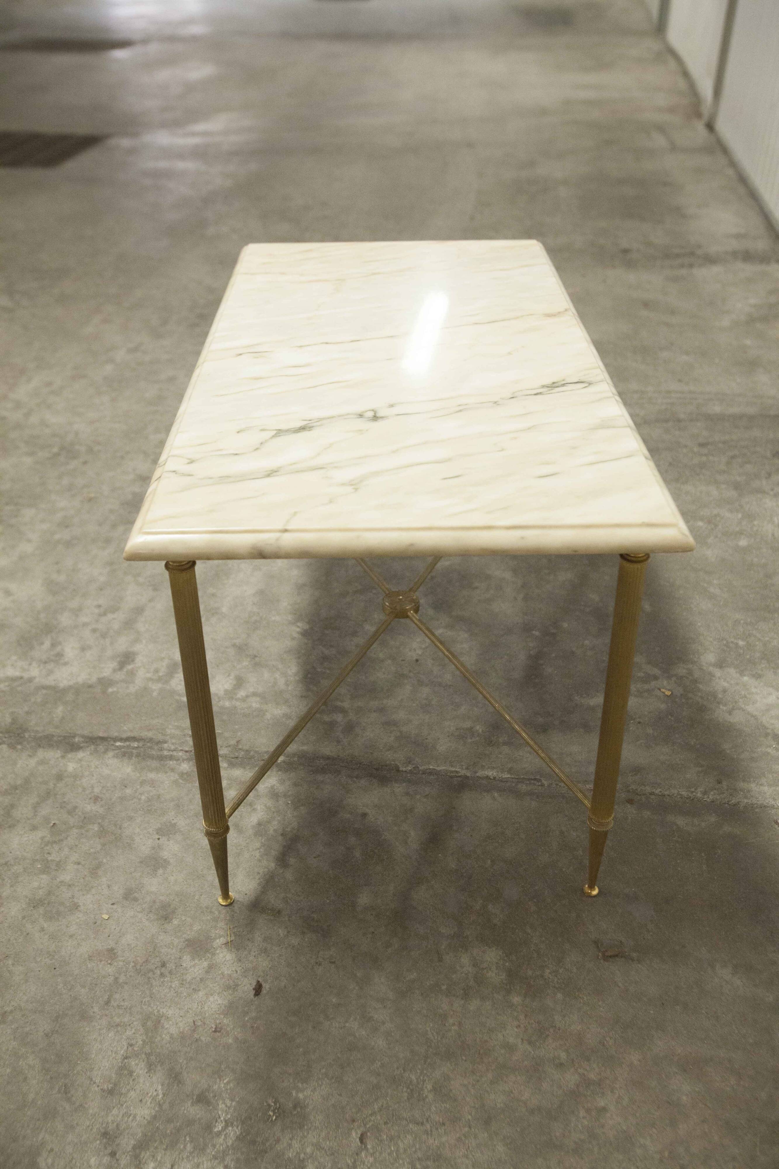 Marble coffee table with brass legs, height 46 cm.