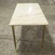 Marble coffee table with brass legs, height 46 cm.