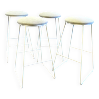 Many metal and beige corduroy bar stools.
