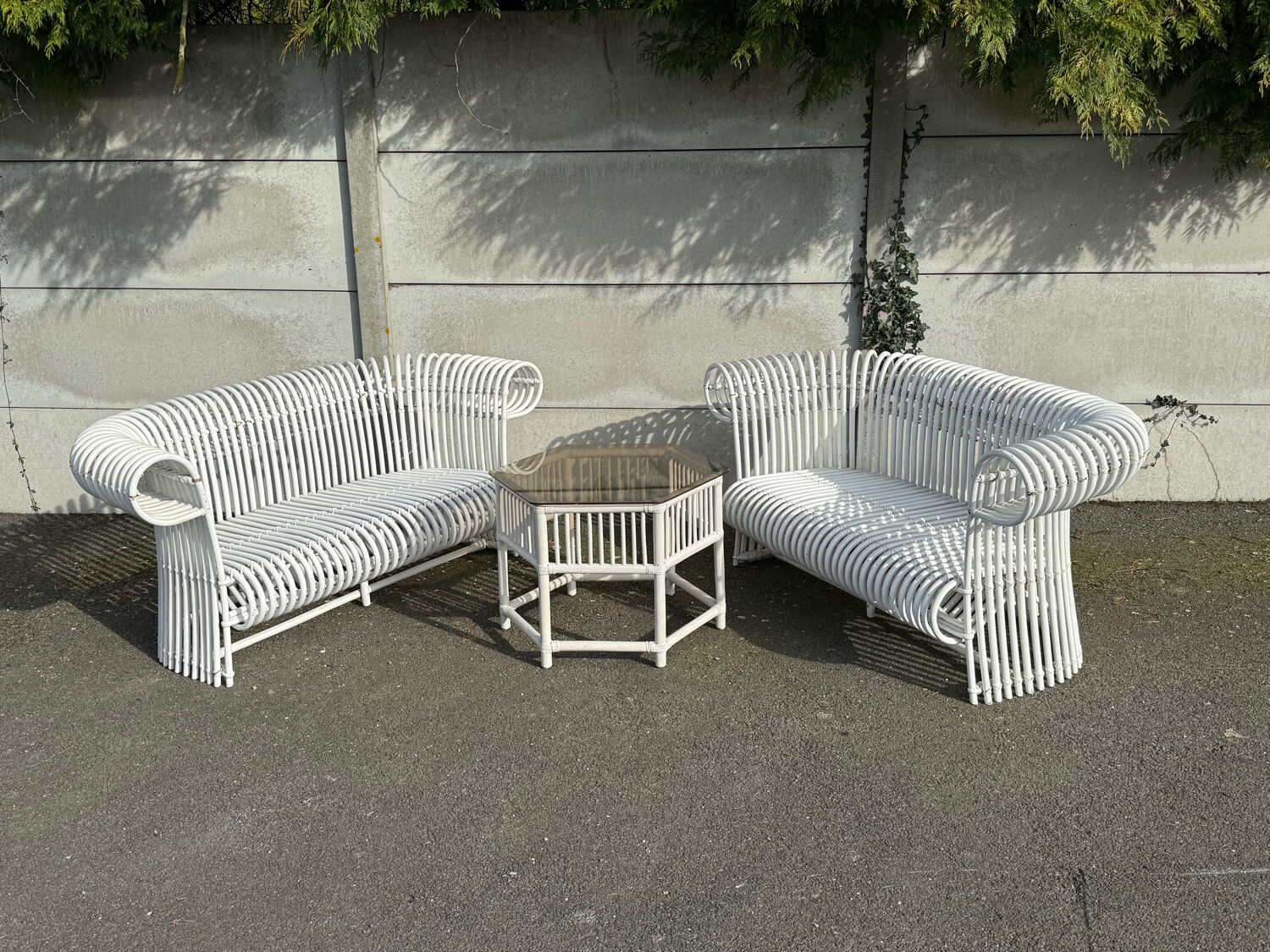 Rattan lounge with two two-seater sofas and a white coffee table.