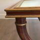 Coffee table in patinated and gilded carved wood with mirror top