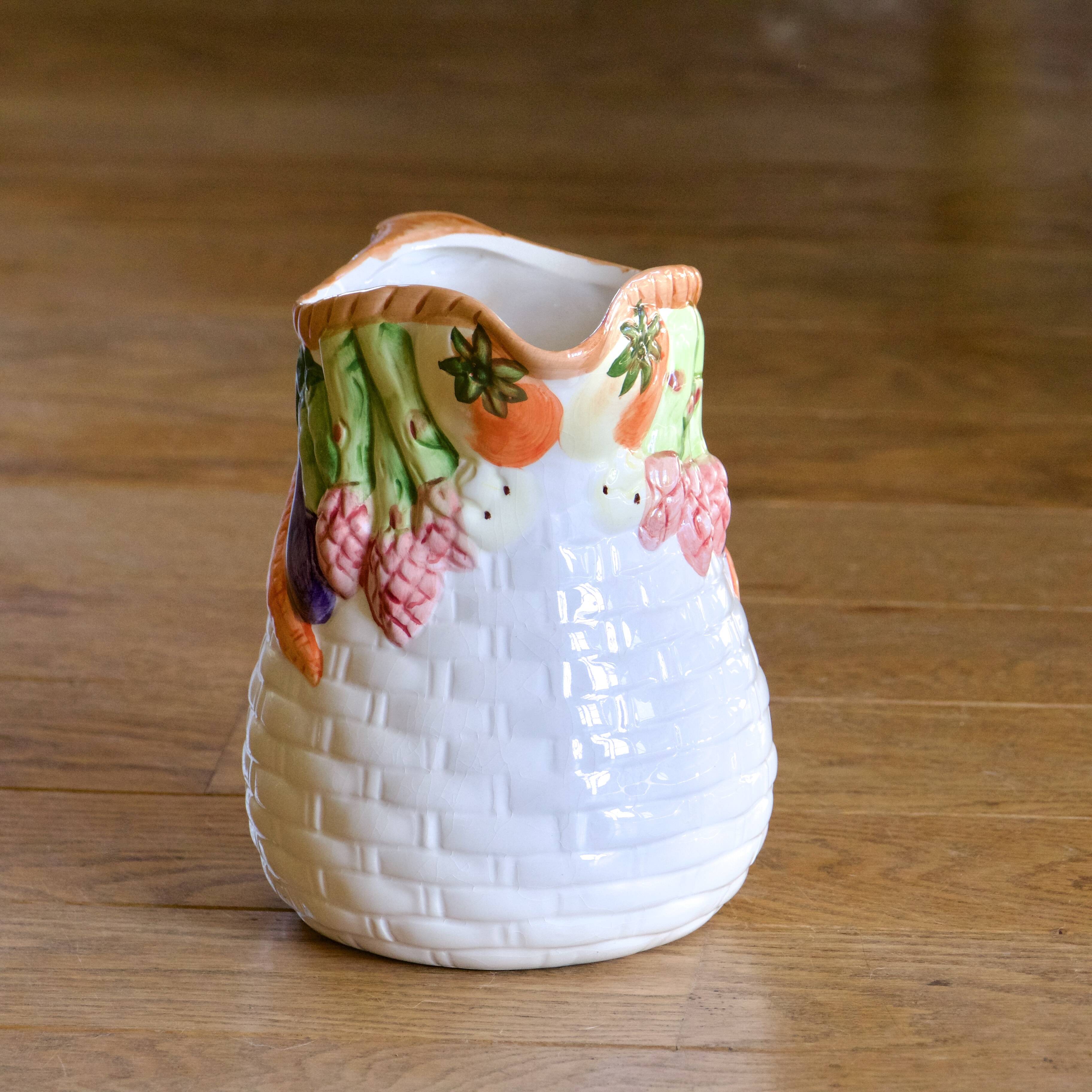 Hand-painted earthenware carafe with a raised vegetable basket design
