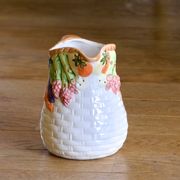 Hand-painted earthenware carafe with a raised vegetable basket design