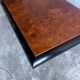 Vintage coffee table in wood burl on a black lacquered base.