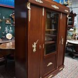 Empire style mahogany display bookcase with gilt bronze decoration and three doors.