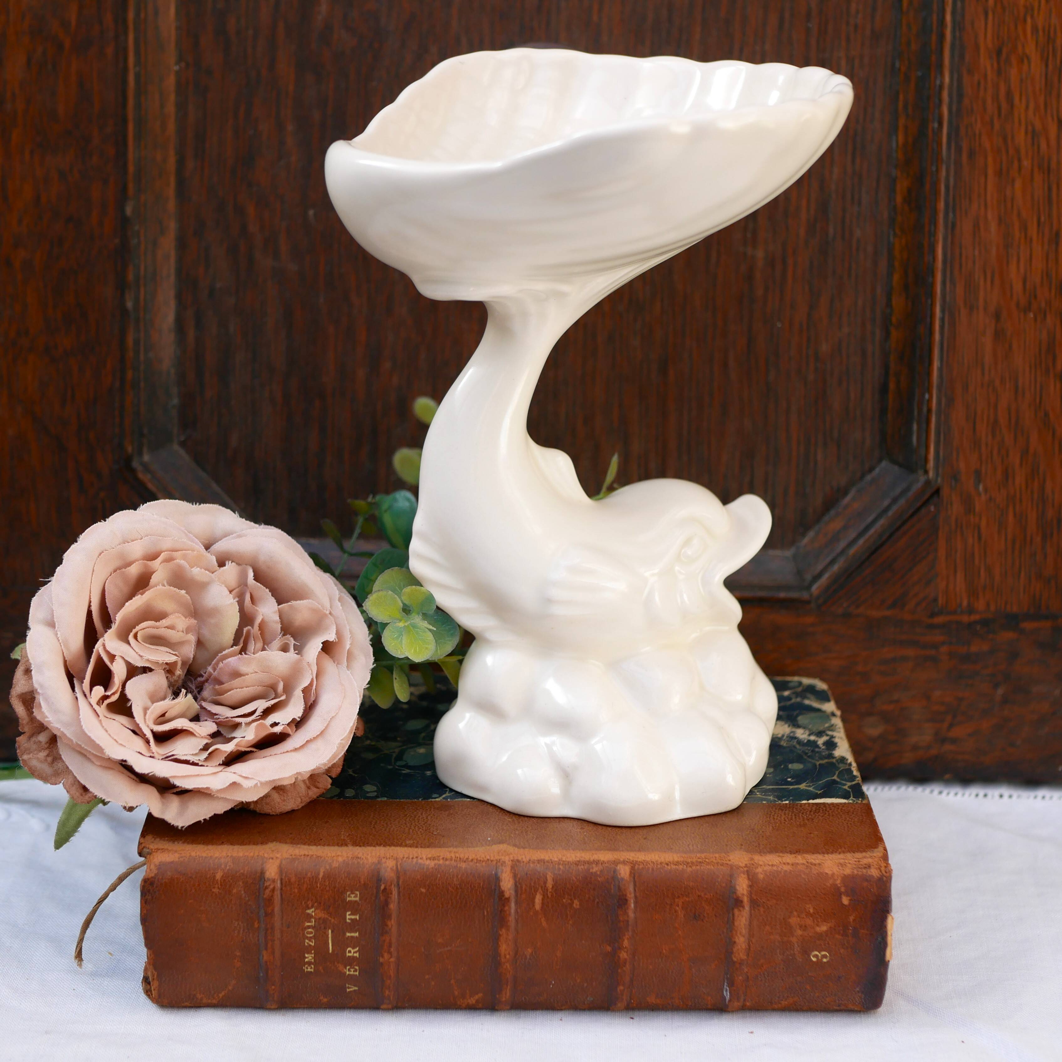 Dartmouth pottery koi carp supporting a shell-shaped dish/vase.