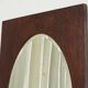 Faceted oval mirror with rectangular oak frame from the 1920s.