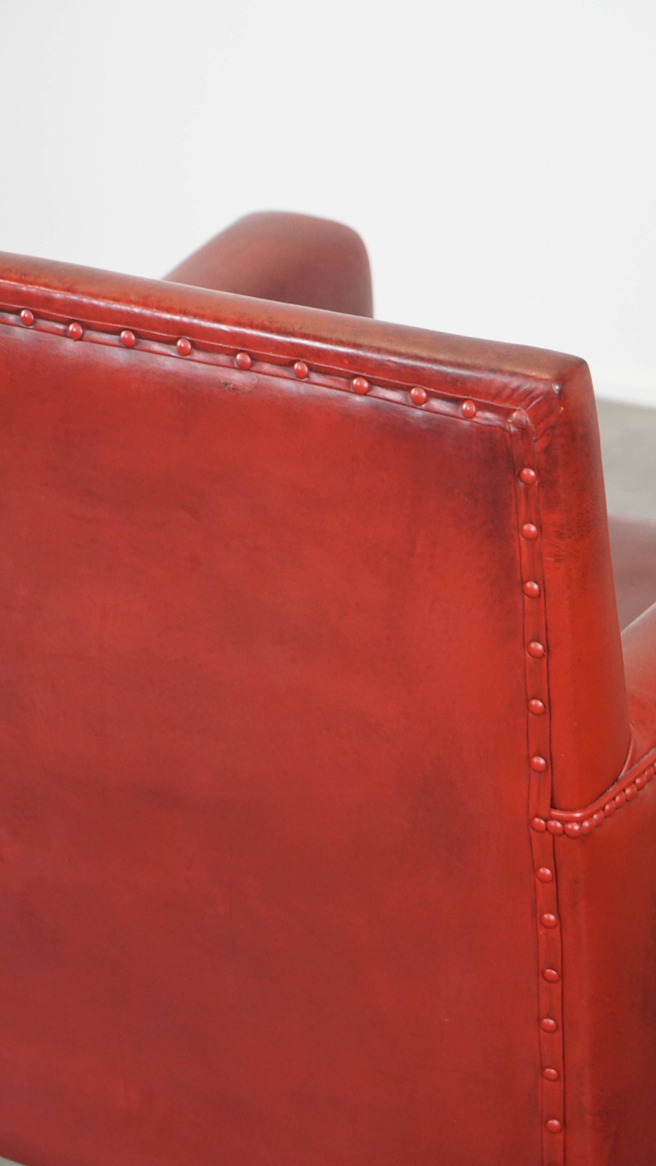 Red-painted armchair made of sheepskin leather