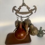 Wall decoration of brass and wood amulets